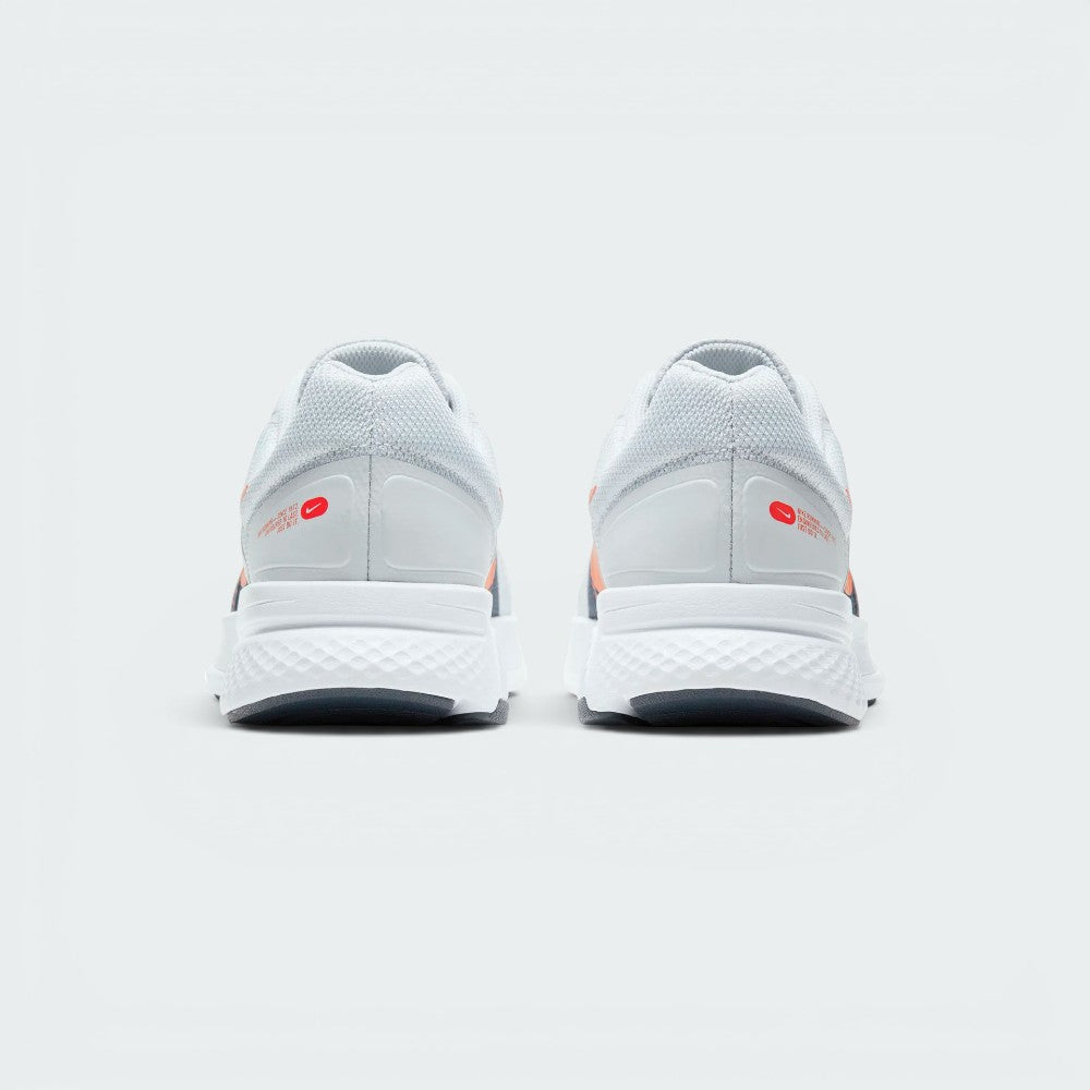 Focuses on the contoured shape of the padded low-cut collar, highlighting the seamless grey heel structure and the printed red Nike Running logo badge sitting squarely above the midsole.