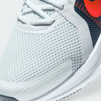 Details the premium precision of the seamless overlays wrapping the front toe cap to defend against debris, showing off the breathable perforations in the mesh up close.