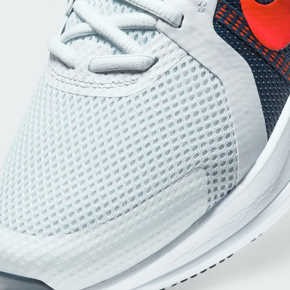 Details the premium precision of the seamless overlays wrapping the front toe cap to defend against debris, showing off the breathable perforations in the mesh up close.
