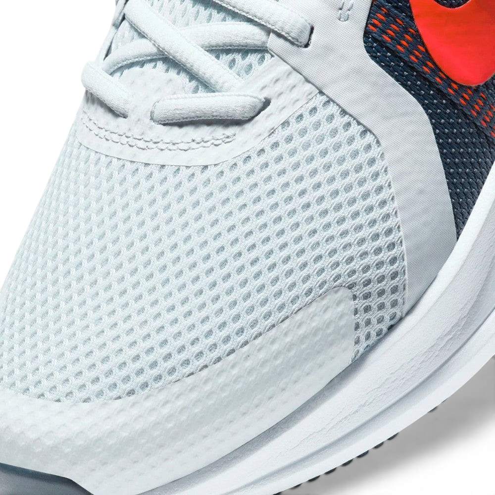 Details the premium precision of the seamless overlays wrapping the front toe cap to defend against debris, showing off the breathable perforations in the mesh up close.