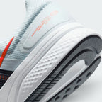 Highlights the "unreal" clean finish where the thick white foam cushioning carrier meets the durable dark traction rubber outsole, framing the clean printed retro text detail on the lateral heel overlay.