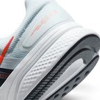 Highlights the "unreal" clean finish where the thick white foam cushioning carrier meets the durable dark traction rubber outsole, framing the clean printed retro text detail on the lateral heel overlay.