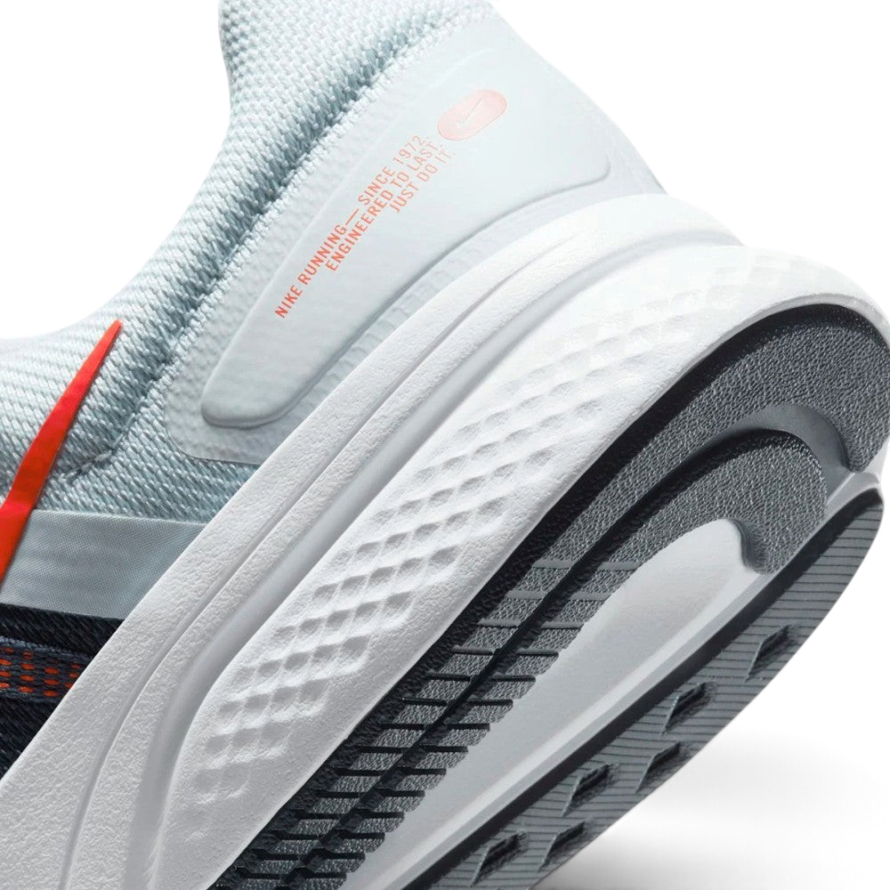 Highlights the "unreal" clean finish where the thick white foam cushioning carrier meets the durable dark traction rubber outsole, framing the clean printed retro text detail on the lateral heel overlay.