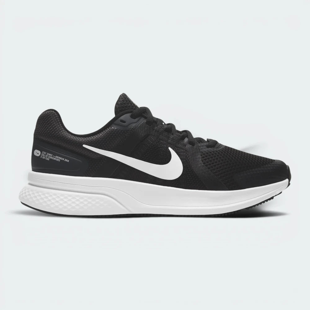 Highlights the high-velocity white Nike Swoosh slashing across the professional depth of the black mesh upper and the contoured dark smoke grey midsole wall.