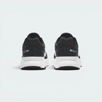 Focuses on the structured mesh heel counter layout and the clean, curved finish of the shock-absorbing foam sole.