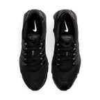 Bottom-down view of the black rubber outsole, showcasing the Waffle traction pattern, circular pod elements, and the central Shox bridge plate.