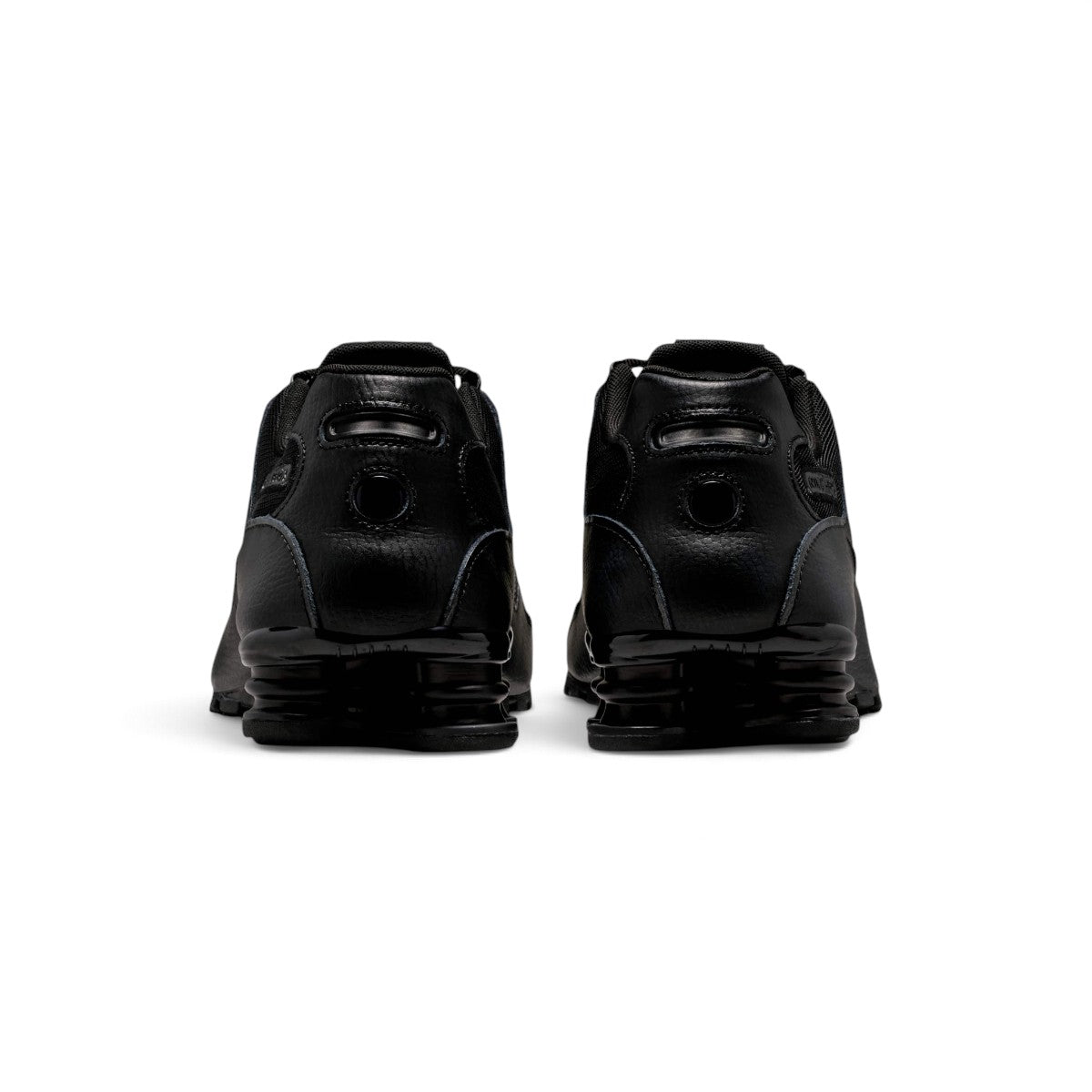 Rear-facing perspective focusing on the structured synthetic heel panels, rear pull loop, and the solid stance of the dual Shox mechanical columns.