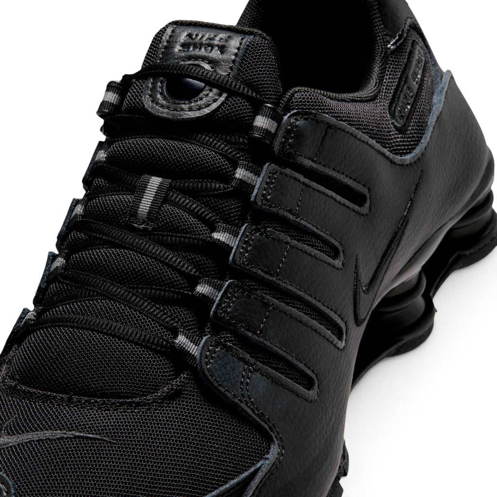 Macro focus on the technical ghillie lacing loops, textured mesh toe box, and the synthetic mudguard overlay.