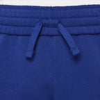 Close-up of the waistband of royal blue sweatpants, showing the elasticized drawstring waist with two matching blue drawstrings.