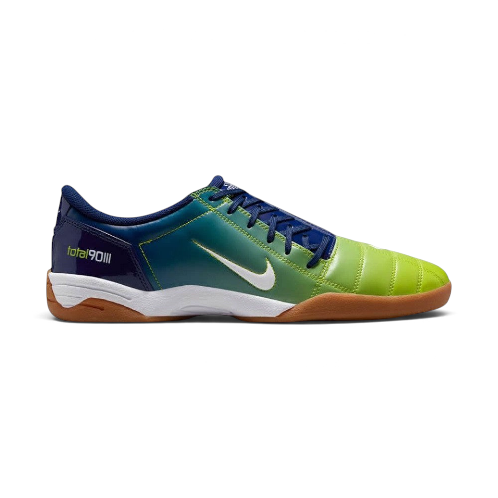Highlights the high-velocity sweep of the contrasting white Nike Swoosh, showing the professional panel stitching of the Blue Void synthetic upper, the atomic green T90 logo on the heel counter, and the low-profile turf outsole