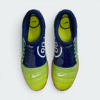 Focuses on the locked-in off-centre lacing layout, displaying the perfect symmetry of the asymmetrical tongue, blue laces, and the enlarged strike zone across the front toe box area.