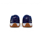Focuses on the contoured shape of the padded ankle collar, highlighting the structured blue heel counter accented with the bold Atomic Green Total 90 badge.