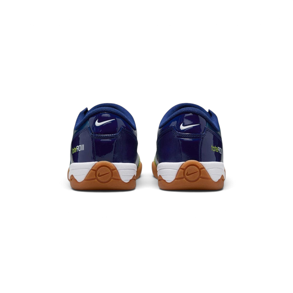 Focuses on the contoured shape of the padded ankle collar, highlighting the structured blue heel counter accented with the bold Atomic Green Total 90 badge.