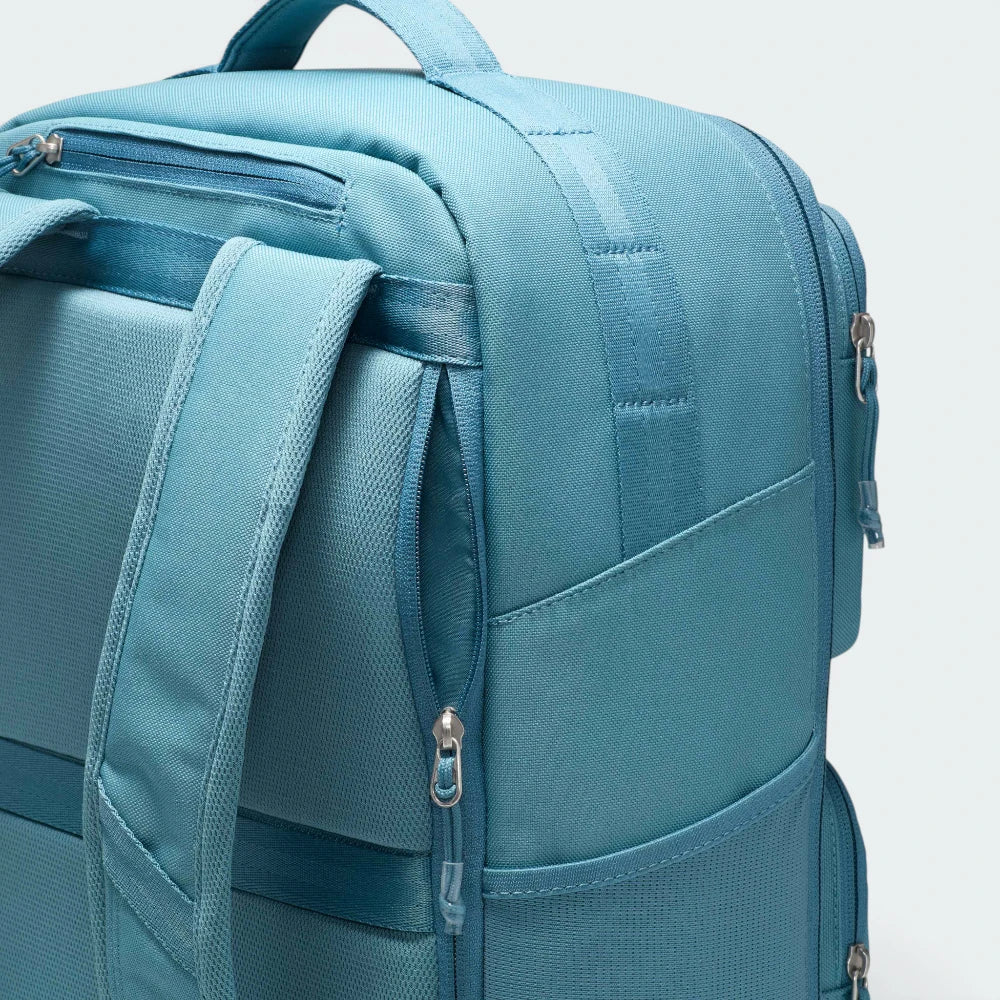 Details the premium precision of the double-lock stitching tracing around the lower utility compartments, showing how the thick zipper tabs slide smoothly under full tension.