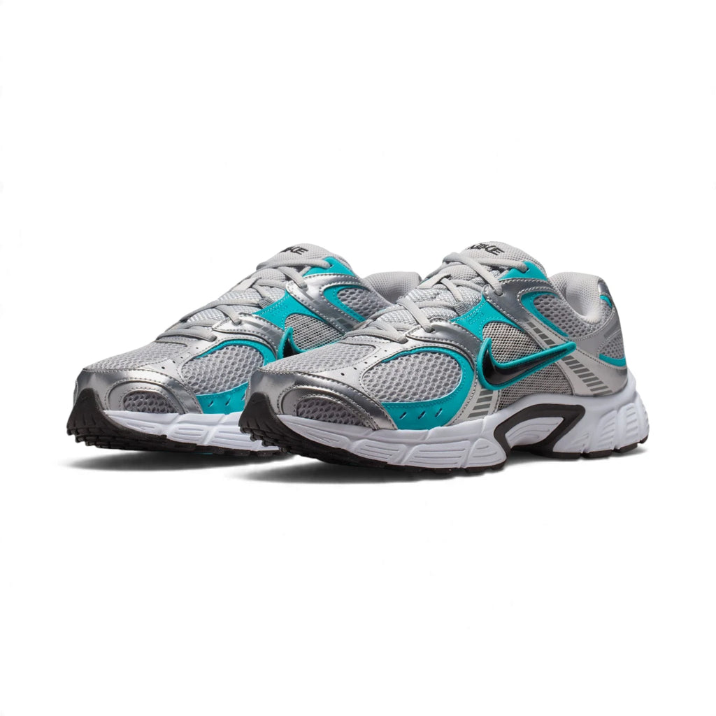 Three-quarter forward angle showcasing both sneakers side by side, highlighting their streamlined athletic silhouette and dynamic grey-and-teal colour blocking.