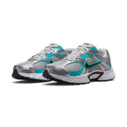 Three-quarter forward angle showcasing both sneakers side by side, highlighting their streamlined athletic silhouette and dynamic grey-and-teal colour blocking.