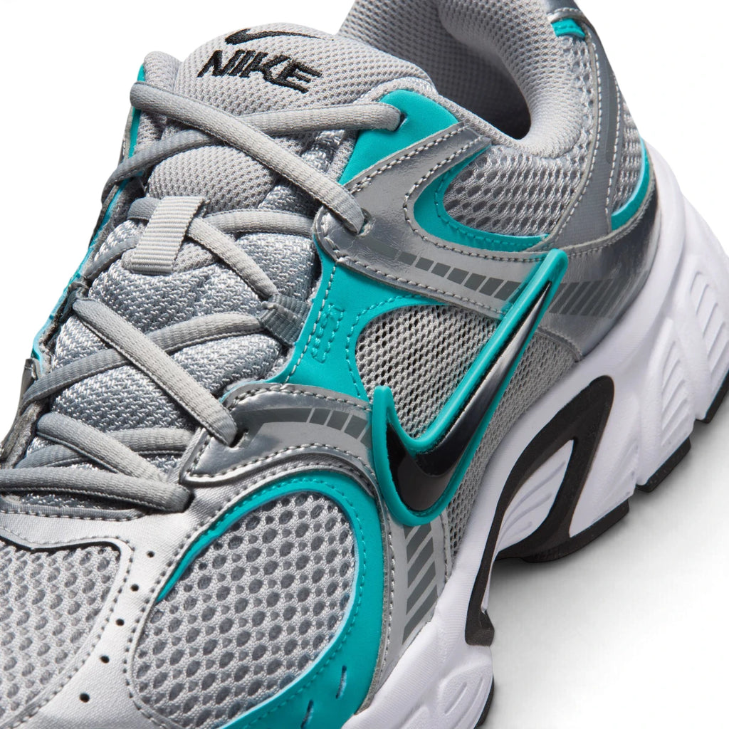 Macro focus on the forefoot and eyestay, detailing the fine mesh weave, grey laces, teal overlays, and black side Swoosh.