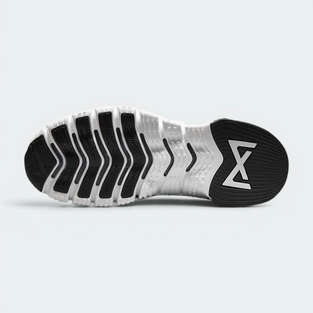 Outsole View: Showing the hybrid traction pattern with Nike Free sipes in the front and a flat, stable lifting base at the rear.