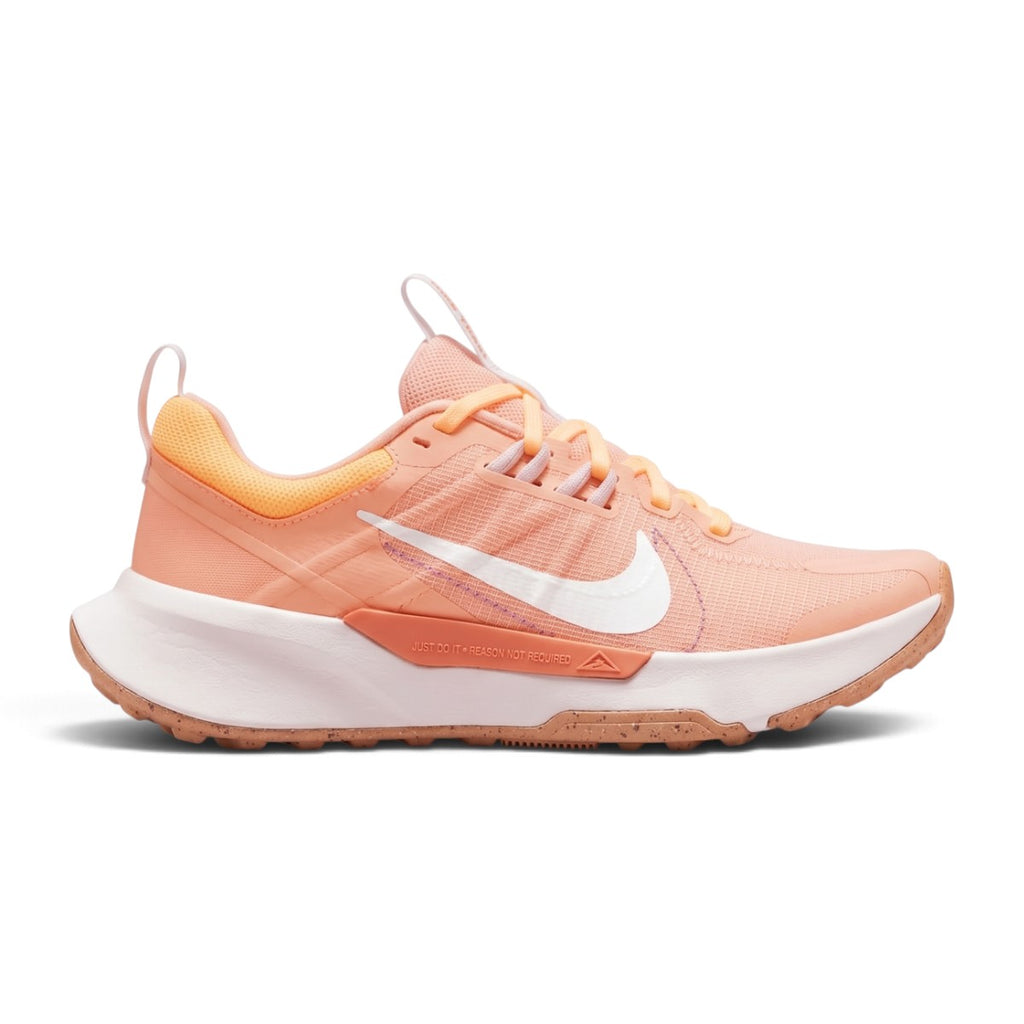 Studio lateral shot of the Nike Women's Juniper Trail 2 Next Nature running shoes in Arctic Orange, White, and Venice, highlighting the durable mesh upper, white Swoosh branding, supportive foam midsole, and rugged traction outsole.