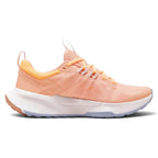 Angled lateral view capturing the sleek peach mesh texturing, protective mudguard overlays, and the streamlined foam midsole contour.