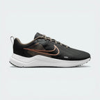 Side Profile Image: The Dark Smoke Grey Downshifter 12, highlighting the gleaming Metallic Silver Swoosh and the elevated dark foam midsole.