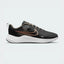 Side Profile Image: The Dark Smoke Grey Downshifter 12, highlighting the gleaming Metallic Silver Swoosh and the elevated dark foam midsole.
