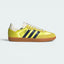 Highlights the high-velocity sweep of the Night Indigo serrated 3-Stripes and the professional, glistening textile depth of the Shock Yellow satin panels leading to the clean cream suede accents.