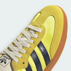 Details the premium stitching lines crossing the velvety suede toe box and the precision eyelet alignment.