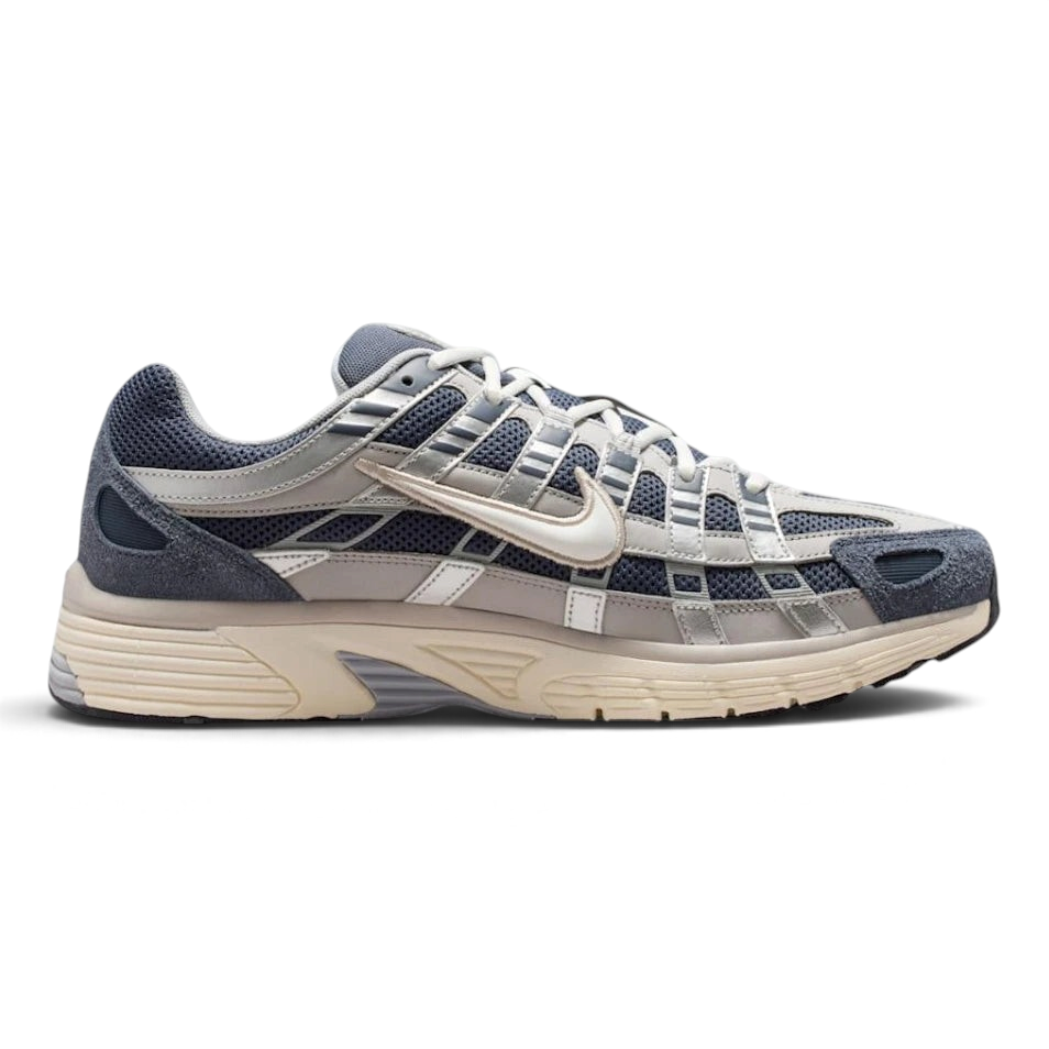 Highlights the high-velocity sweep of the technical overlays, showing the professional, multi-layered texture of the Thunder Blue leather panels resting over the Slate mesh base, and the cream-toned Pale Ivory midsole wall. Main image