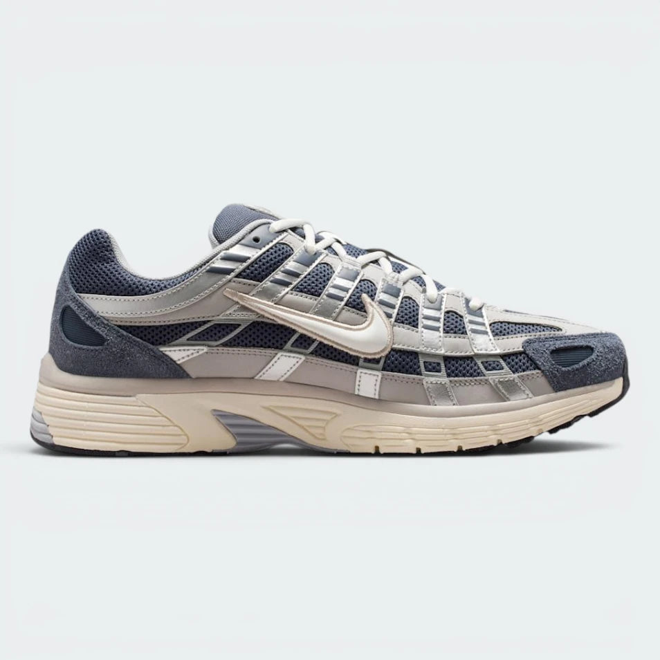 Highlights the high-velocity sweep of the technical overlays, showing the professional, multi-layered texture of the Thunder Blue leather panels resting over the Slate mesh base, and the cream-toned Pale Ivory midsole wall.