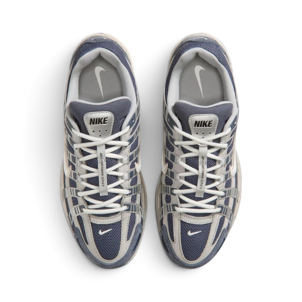Focuses on the locked-in traditional lacing layout, displaying the perfect symmetry of the navy mesh tongue, the vertical structural lace bands, and the breathable mesh paneling guarding the front toe box area.