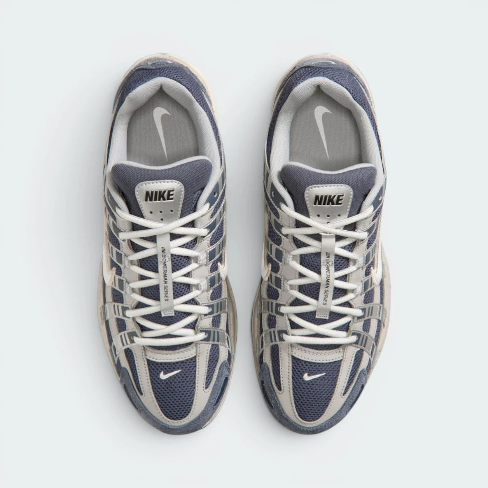 Focuses on the locked-in traditional lacing layout, displaying the perfect symmetry of the navy mesh tongue, the vertical structural lace bands, and the breathable mesh paneling guarding the front toe box area.