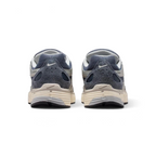 Focuses on the contoured shape of the padded low-cut collar, highlighting the reflective accents and the vertical leather overlay strip tracking down the rear spine.