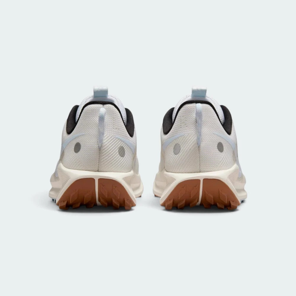 Focuses on the rear profile, highlighting the flecked pull loops, circular reflective dots on the heel counters, and the wide footprint of the ReactX midsole base.