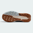 Displays the full-length Nike Trail All-Terrain Compound (ATC) rubber sole, showcasing the multi-directional lug grid and central stability shank with trail logo.