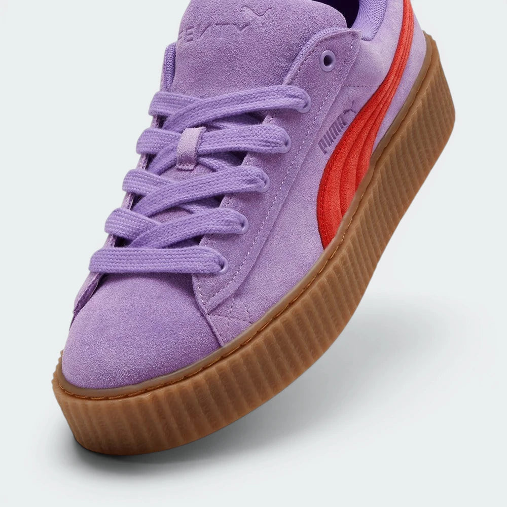 Details the high-definition suede grain and the precision of the gold-tone lace tips.