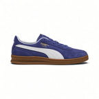 Displays the lateral silhouette featuring the rich Blue Crystal suede upper, crisp PUMA White tumbled leather Formstrip, gilded metallic "PUMA INDOOR" script, white collar lining, and low-profile gum rubber cupsole with debossed PUMA branding.