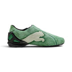 Medial perspective highlighting the inner profile of the shoe, dominated by an oversized off-white suede leaping PUMA Cat graphic sewn directly into the green hairy suede chassis above the sculpted black heel cradle.