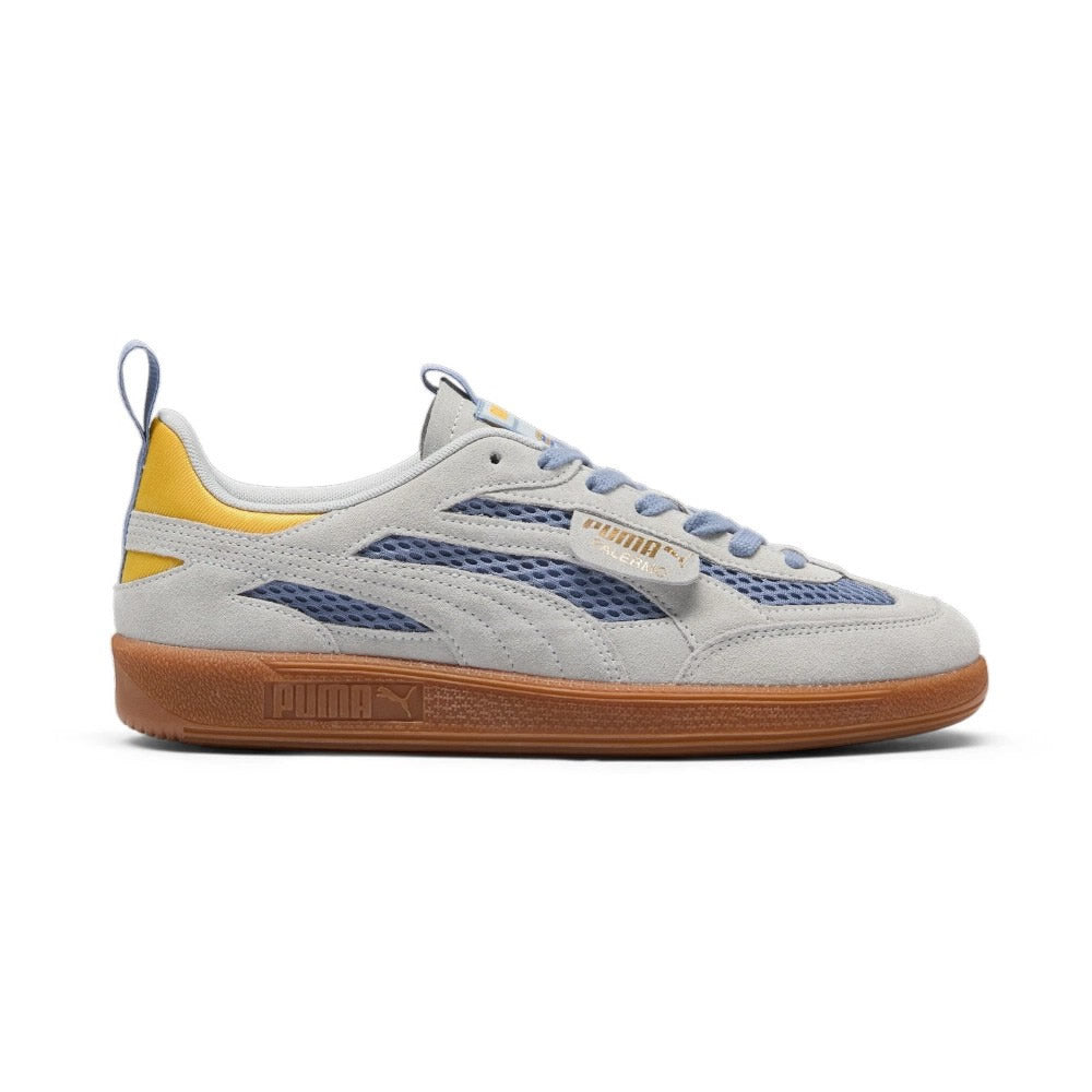 Lateral view showing the Filtered Ash blue-grey mesh underlay, premium grey suede Formstrip and overlays, signature lateral flap tab with gold foil "PUMA Palermo" branding, vibrant mustard yellow satin heel wrap, and textured gum rubber cupsole. Main image