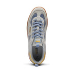 Direct overhead look at the shoe, displaying the grey suede T-toe mudguards framing the blue mesh toe inserts, flat lavender-blue laces, light grey tongue with woven "PUMA / KidSuper Studios" tab, and grey co-branded footbed.