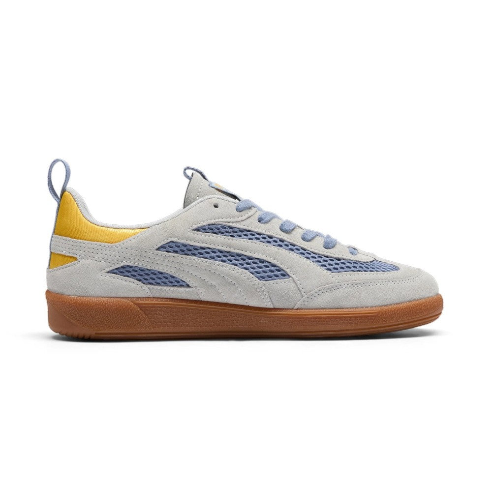 Medial perspective highlighting the inner profile of the shoe, displaying the cut-out suede panelling exposing the breathable blue-grey mesh underlays, yellow satin collar rim, and clean gum rubber cupsole wall.