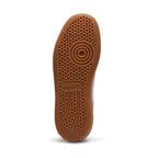 Full-length bottom profile showing the gum rubber outsole, highlighting the multi-pod geometric suction tread pattern, forefoot pivot circle, perimeter flex grooves, and central recessed PUMA logo bridge.