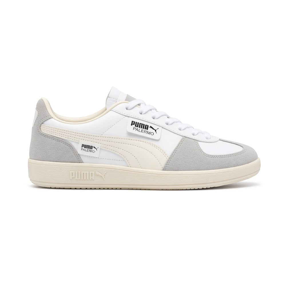 Lateral view showing the crisp Puma White smooth leather upper, Cool Light Gray suede T-toe and heel overlays, Sugared Almond suede Formstrip, distinctive fold-over lateral PUMA Palermo flap tab, and textured off-white rubber cupsole with debossed PUMA branding. Main image