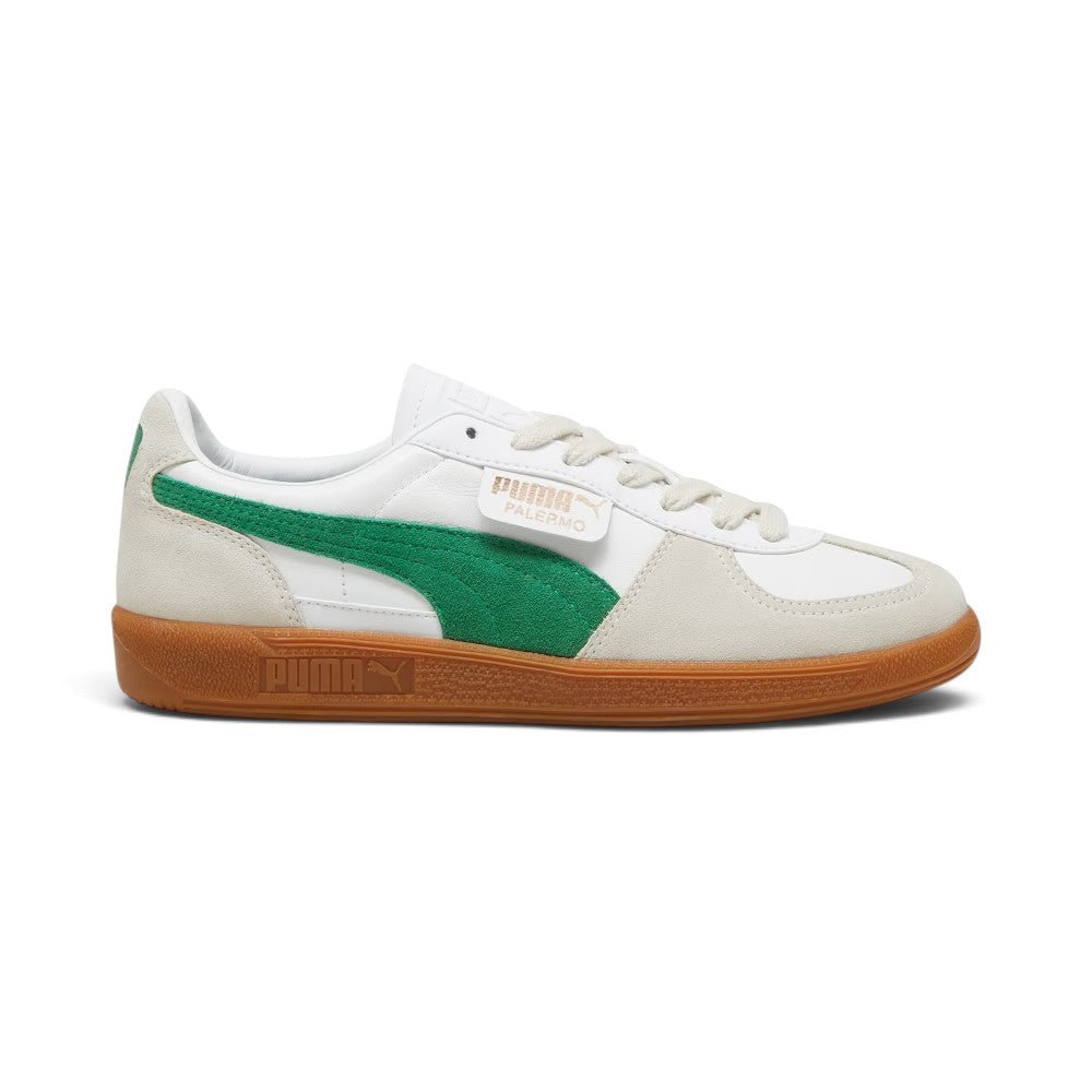Lateral view showing the crisp PUMA White smooth leather upper, Vapor Grey suede T-toe and heel overlays, rich Archive Green suede Formstrip, signature fold-over lateral flap tab stamped with gold foil PUMA branding, and textured gum rubber cupsole with debossed PUMA lettering.