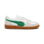 Lateral view showing the crisp PUMA White smooth leather upper, Vapor Grey suede T-toe and heel overlays, rich Archive Green suede Formstrip, signature fold-over lateral flap tab stamped with gold foil PUMA branding, and textured gum rubber cupsole with debossed PUMA lettering.