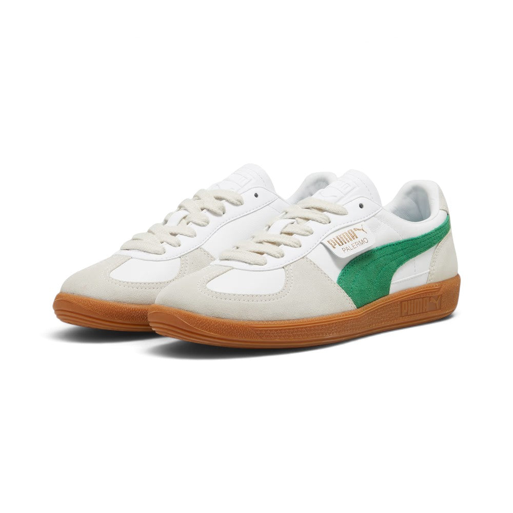 Forward three-quarter angle showcasing both shoes side by side, highlighting the low-profile terrace silhouette, flat off-white laces, contrasting suede T-toe mudguards, green suede Formstrips, and clean gum rubber soles.