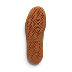 Full-length bottom profile showing the gum rubber outsole, highlighting the multi-pod suction cup tread pattern, circular forefoot pivot ring, perimeter grip blocks, and central recessed PUMA logo bridge.