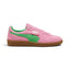 Displays the lateral view showing the rich Pink Delight suede upper, vivid PUMA Green smooth leather Formstrip, fold-over lateral flap tab with metallic gold PUMA branding, PUMA Green heel collar accent, and textured gum rubber cupsole with debossed PUMA lettering.