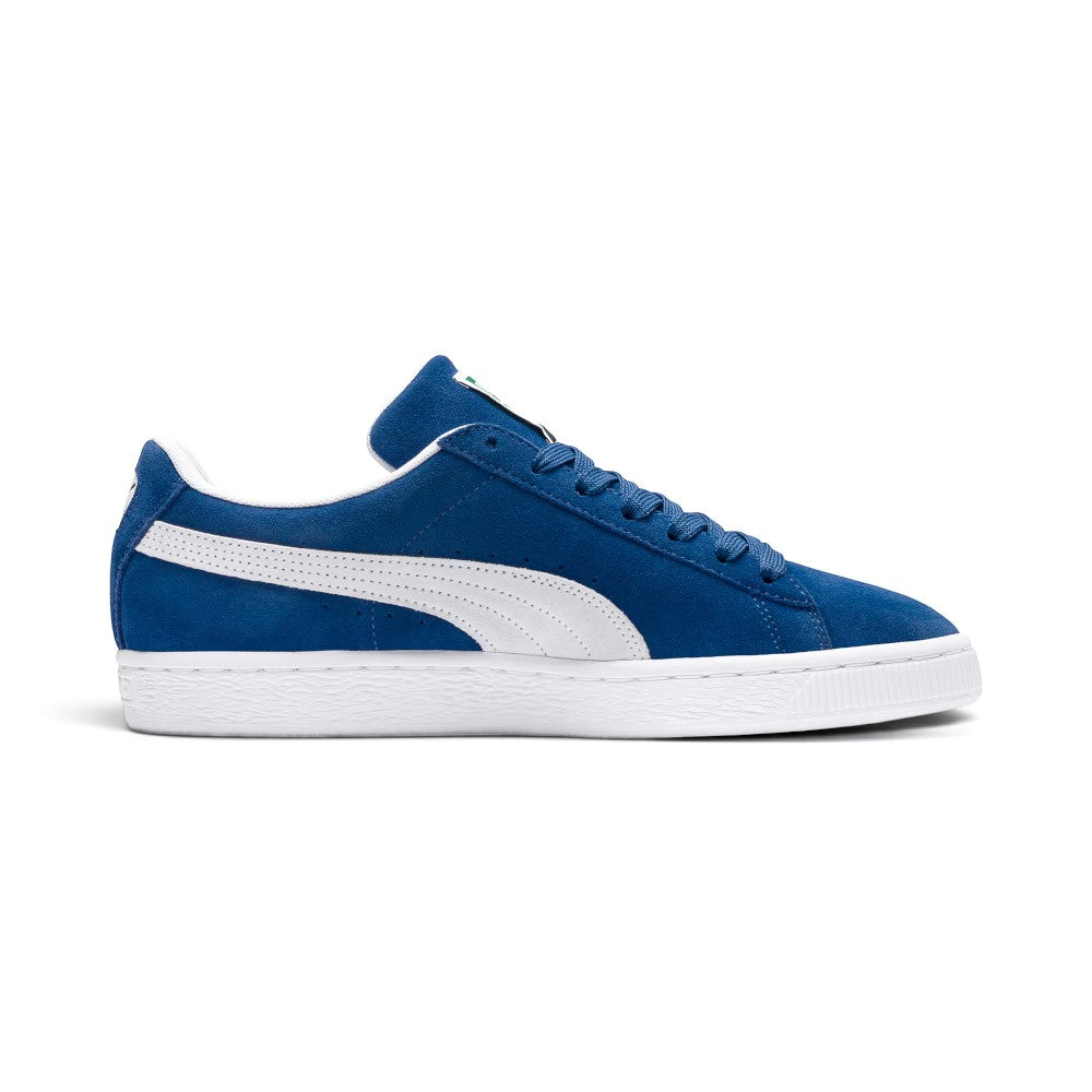 Medial perspective highlighting the inner profile of the shoe, featuring the solid Olympian Blue suede quarter, White leather Formstrip, clean white foxing stitch, and textured midsole sidewall.