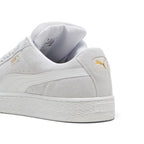 Close-up rear angle focusing on the reinforced suede heel counter, thick puffy Achilles collar padding, white leather heel moustache tab stamped with a gilded metallic PUMA Cat logo, and chunky textured cupsole base.